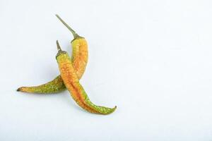 Top view of two dried green hot peppers photo