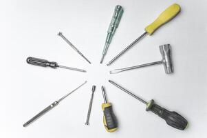 Different old screwdrivers on a white background. Cross, minus and with a rubber handle against electric shock. High quality photo