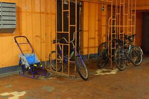 Bicycles and Strollers parked in an Urban Storage Area designed for community convenience photo