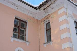 Architectural Details Highlighting the Cracks on a Corner of a Historical Building photo