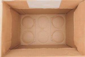 An empty cardboard box that comes with circular inserts designed for various purposes photo