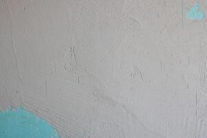 A textured wall with striking turquoise accents creates captivating visual appeal photo
