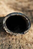A CloseUp View of a Weathered and Rusty Pipe Found in Untamed Natural Surroundings photo