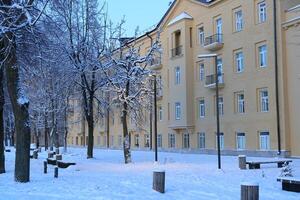 A Serene and Peaceful Winter Scene Featuring SnowCovered Buildings in a Charming Setting photo