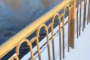 Golden Railing Set Against Calm Waters in a Serene Winter Landscape and Setting Atmosphere photo
