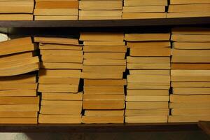 A collection of stacked books on a shelf captures the essence of knowledge and imagination photo