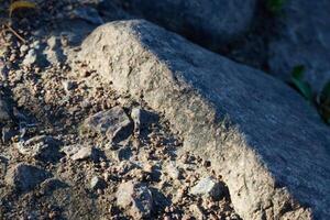 A captivating closeup view of a natural stone surface illuminated beautifully by bright sunlight photo