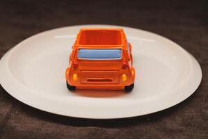 A Colorful Toy Car Placed on a Plate An Engaging and Creative Concept Displaying Playfulness photo