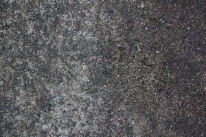 Textured Surface of Ground Featuring Distinct Dark and Light Variations and Patterns photo