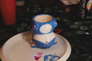 An Uniquely Whimsical and Colorfully Painted Shark Mug Featuring a Stunning EyeCatching Design photo
