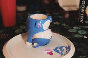 A beautifully designed Cute Blue Whale Mug resting elegantly on a decorative Plate photo