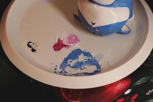 Whimsical Art Displayed on a Beautiful Plate Made with Colorful and Unique Ceramics photo