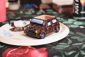 A Stunning and Visually Artistic Miniature Car Model Displayed Elegantly on an Exquisite Plate photo