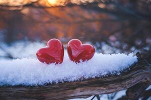 Heart shaped objects on snow covered branch evoke warmth in a wintry scene photo
