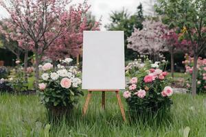 Garden Setting Easel with Canvas Surrounded by Colorful Blossoms photo