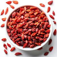 Red dried goji berries in a bowl on a white background. photo