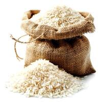 Jute bag with rice isolated on white background. Close up. photo