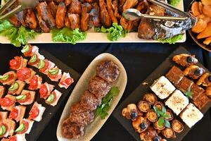 A buffet table with various types of food photo