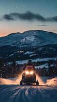 Snowmobile Adventure at Night in the Majestic Mountains photo
