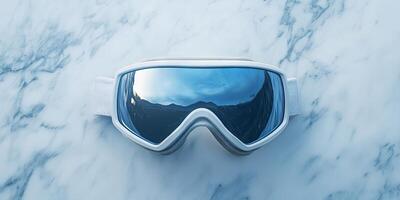 Stylish White Ski Goggles Reflecting a Winter Landscape photo
