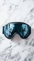 Stylish Black Ski Goggles Reflecting Mountain Views photo
