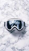 Stylish White Ski Goggles on Marble Background photo