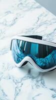 Stylish White Ski Goggles on Marble Surface photo