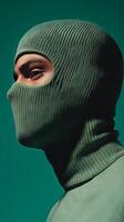 Closeup Portrait of a Person Wearing a Green Knitted Mask photo