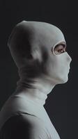 Close-up Portrait of a Person in a White Hood photo