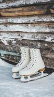 Elegant White Ice Skates on Snowy Winter Day photo