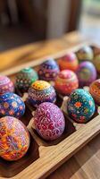 Hand Painted Easter Eggs Displayed on Wooden Tray photo