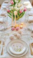 Elegant Easter Table Setting with Tulips and Painted Eggs photo