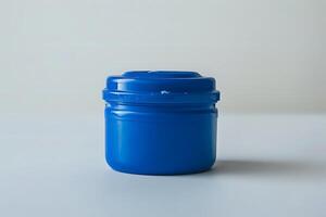 Exploring the Design of a Simple, Cylindrical, Blue Plastic Container with a Snap-On Lid. A Study in Everyday Object Aesthetics and Functionality, Examining Material Choices and Manufacturing Process photo