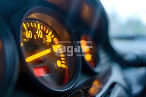 Illuminated Speedometer Needle Displays Vehicle Speed and Fuel Level,Showing Precise Measurements with Bright Yellow Illumination in a Car Dashboard at Night.Dashboard Design and Automotive Instrument photo