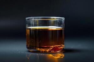 Amber Liquid in Glass. A Study of Color, Texture, and Light Reflection in a Transparent Vessel, Showing Viscosity and Density Properties with Submerged Object. Captivating Still Life Photography. photo