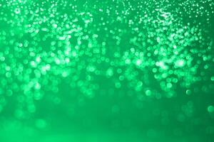 Green bokeh background with sparkles photo