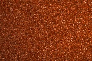 A close up of a red glittery surface photo
