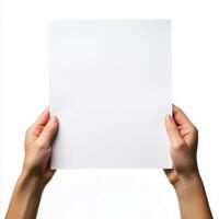 Hands hold a blank sheet of paper against a white background in a minimalist setting photo