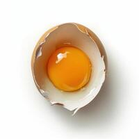 Freshly cracked egg shell with bright yellow yolk highlighted on a neutral background photo