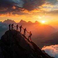 Group of hikers reaching the summit at sunset in the mountains with stunning views photo