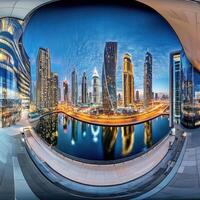 City skyline illuminated at dusk with modern architecture and reflections on the water photo