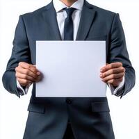Professional man in formal attire holding a blank document in a studio setting during the daytime photo
