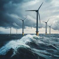 Wind turbines stand tall against dark clouds and crashing waves in a coastal setting during stormy weather photo