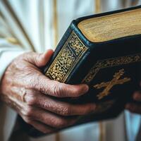 Holding a sacred book during a religious ceremony in a solemn setting photo