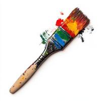 Colorful paintbrush with vibrant paint splatters on a clean surface photo