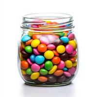 Colorful candy jar filled with assorted chocolates and sweets on a white background photo