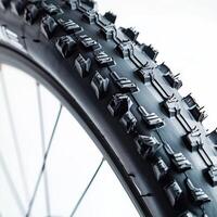Close-up view of a mountain bike tire highlighting tread design and texture for optimal grip on rugged terrain photo