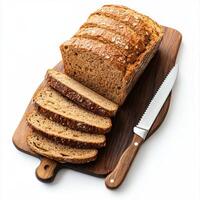 Freshly baked whole grain bread displayed on a wooden cutting board with slices ready for serving at a cozy kitchen setting photo