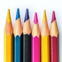 Colorful arrangement of colored pencils lying on a white background showcasing a variety of hues and sharp points photo
