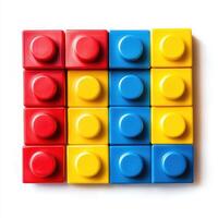 Colorful arrangement of building blocks in red, blue, and yellow patterns on a white background inspiring creativity photo